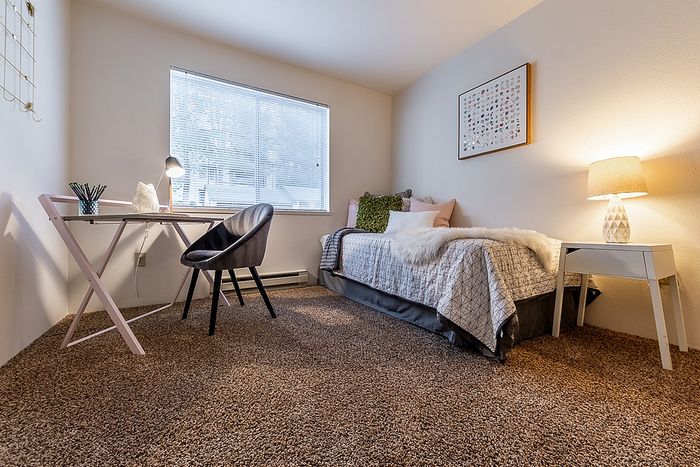 Bright bedroom layout featuring a small desk setup at Berkeley Heights Apartment Homes.