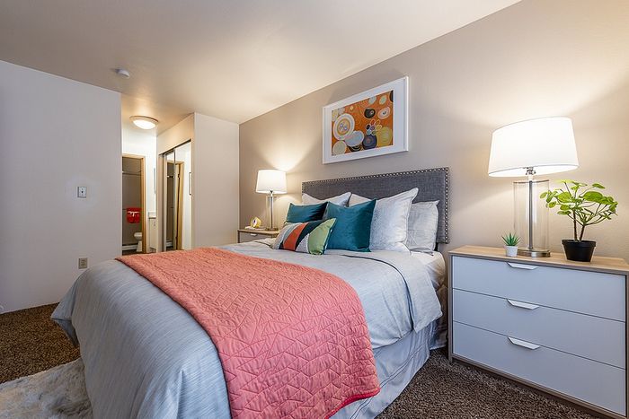 Modern bedroom styling showcasing a colorful accent blanket at Berkeley Heights Apartment Homes.