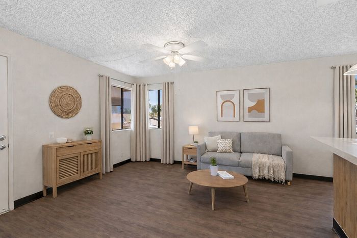 Virtually Staged living room at Orchard Mesa with a couch, coffee table and entry table