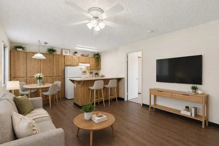 Virtually Staged living and dining room at Orchard Mesa with a dining table, coffee table and couch