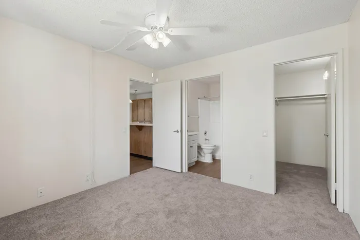 Bedroom at Orchard Mesa showing attached bathroom and walk-in closet