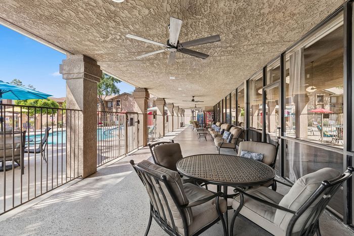Covered patio at Orchard Mesa with fans and tables and chairs