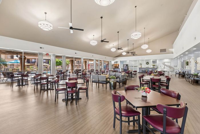 Community room with seating and a piano and a view out to the pool