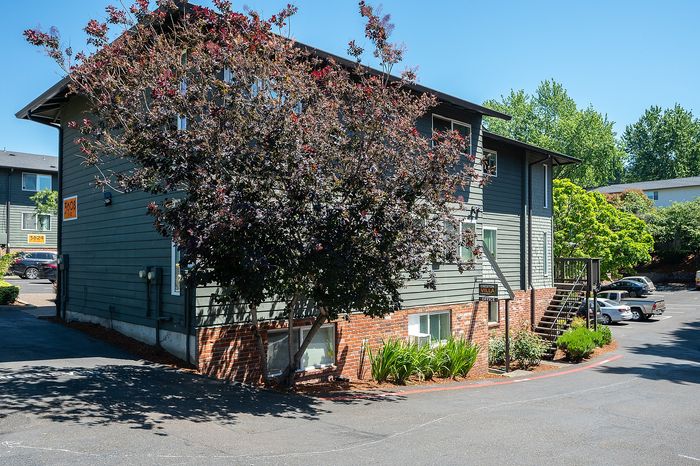 Creston Villa exterior parking lot with large tree