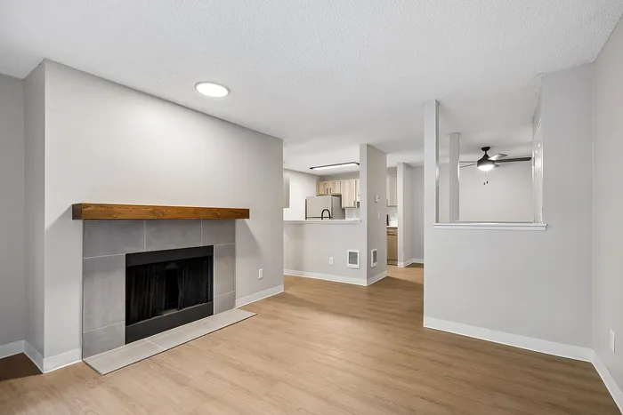 Living Room at Timber Flats with wood floors and view into kitchen and entryway