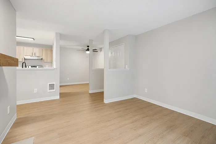 Living Room at Timber Flats Unit E101 with view into entryway and wood floors