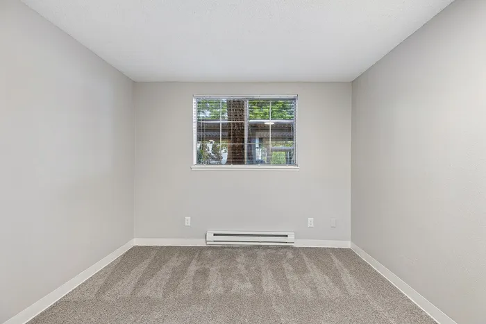 Bedroom at Timber Flats with carpet and a window