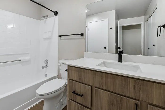 Bathroom at Timber Flats unit E101, wood cabinets and black hardware