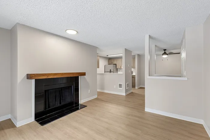 Living Room with black tile and wood mantle