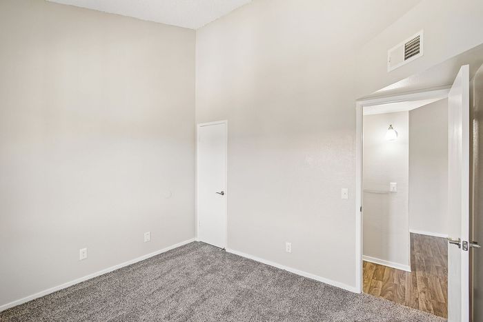 bedroom at ventura villas with tall ceilings and carpet