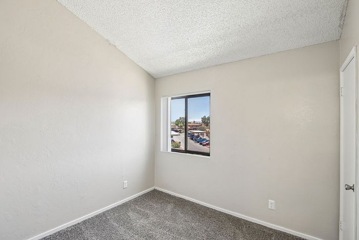 secondary bedroom at ventura villas with a window and carpet