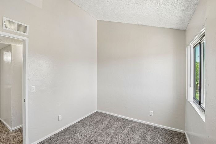 secondary bedroom at ventura villas with a window and carpet