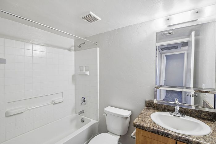 bathroom at ventura villas 2x1 with tub/shower and toilet and shower
