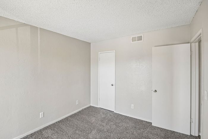 bedroom at ventura villas with closet and carpet
