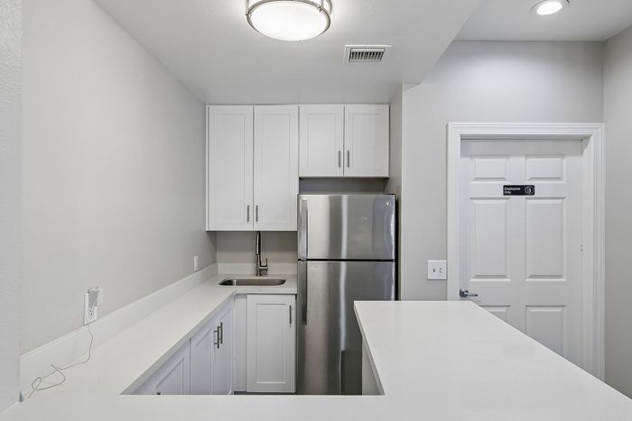 community room at ventura villas with a fridge, sink and storage