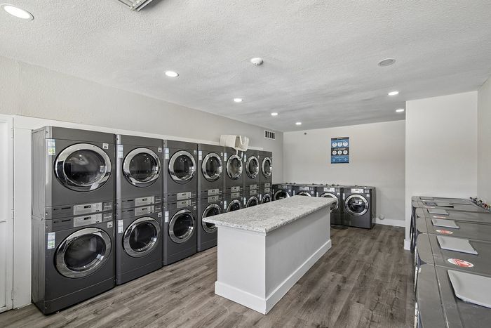laundry facility at ventura villas with island and full-size washer and dryers
