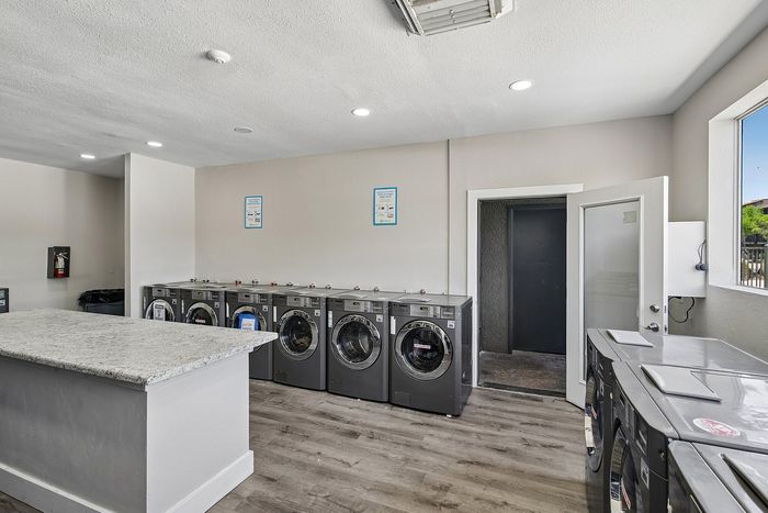 laundry facility at ventura villas with island and full-size washer and dryers