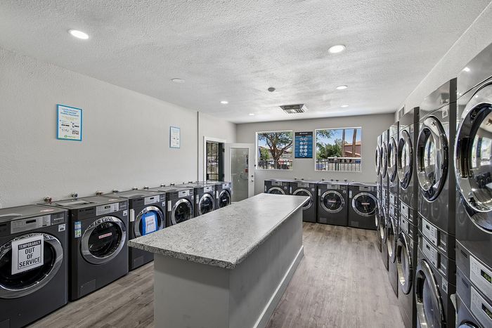 laundry facility at ventura villas with island and full-size washer and dryers