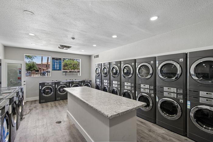 laundry facility at ventura villas with island and full-size washer and dryers