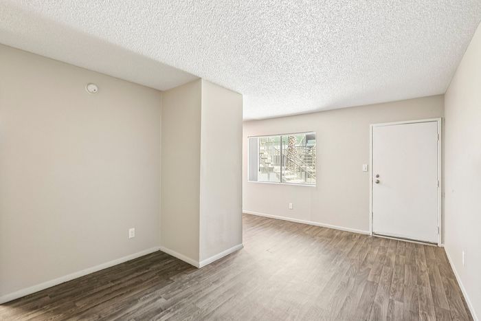 Living area in a Deer Valley Village home featuring wood-style flooring and a large window.