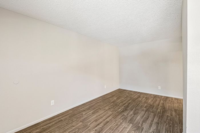Corner of a Deer Valley Village living space featuring wood-style vinyl flooring and neutral paint.