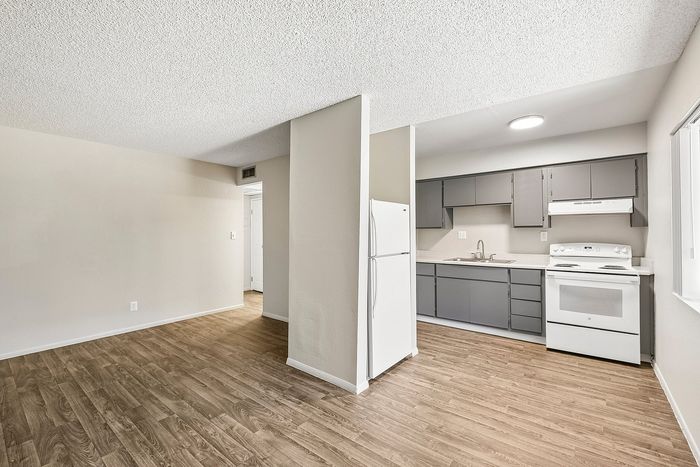 Deer Valley Village kitchen with grey cabinetry, white appliances, and vinyl plank flooring.