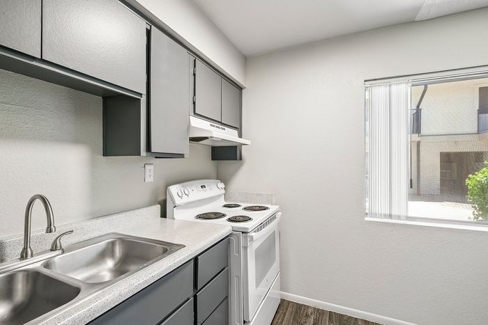 Kitchen workspace in Deer Valley Village featuring a double stainless steel sink and grey cabinetry.