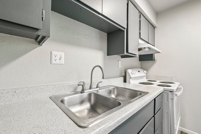 Close-up of a double stainless steel sink and laminate countertop at Deer Valley Village.