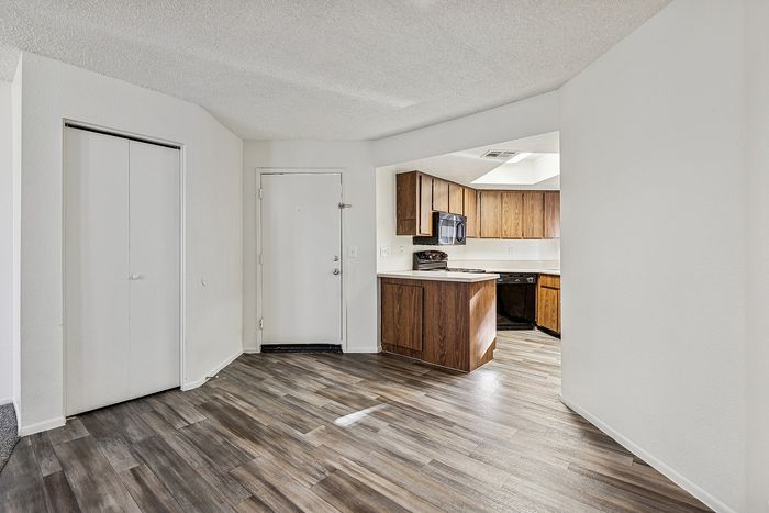 Dining area at Silver Creek with wood floors and view into kitchen