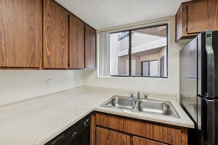 Kitchen at Silver Creek with black appliances and wood cabinets