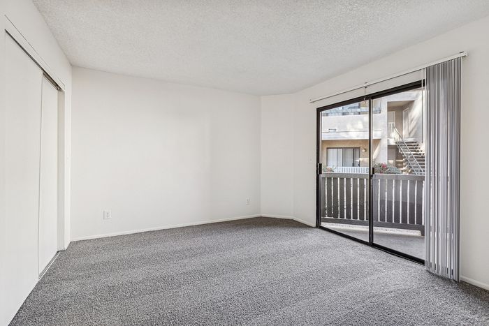 Bedroom at Silver Creek with carpet and a sliding glass door and white walls