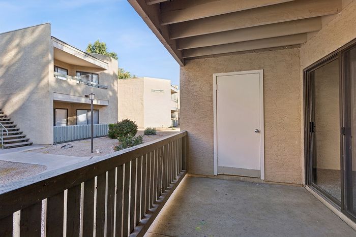 Patio at Silver Creek with cement floor and wood railing