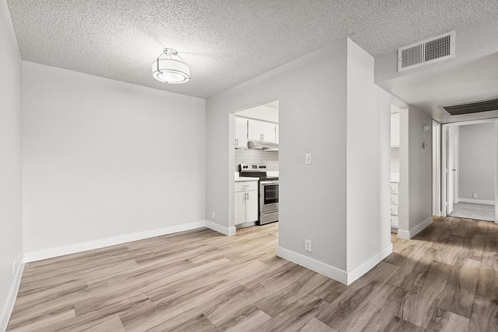 Dining area at peoria grand with wood floors and a light