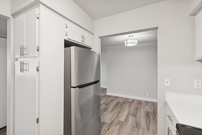 Kitchen at Peoria Grand with stainless steel fridge and white cabinets
