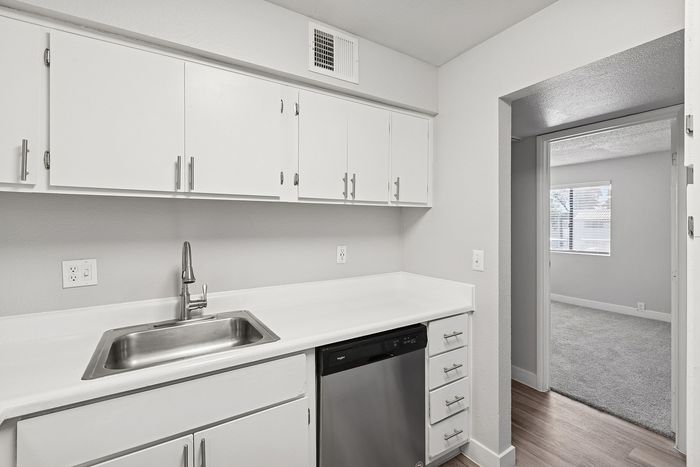 Kitchen at Peoria Grand with stainless steel appliances and all white cabinets