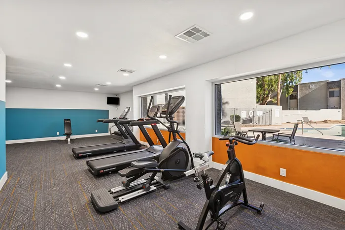 gym at peoria grand with view out to the pool