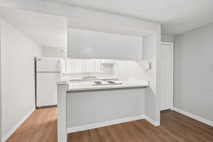 Kitchen with space for barstools and al white appliances