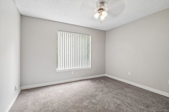 Bedroom at Creekwood with window and Ceiling fan