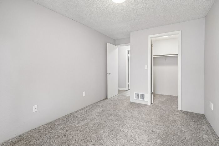 Bedroom at Creekwood with a closet and new carpet