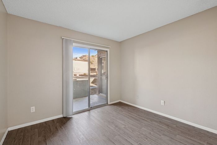 Solaris at Shadow Mountain bedroom with sliding glass door access to a private patio.