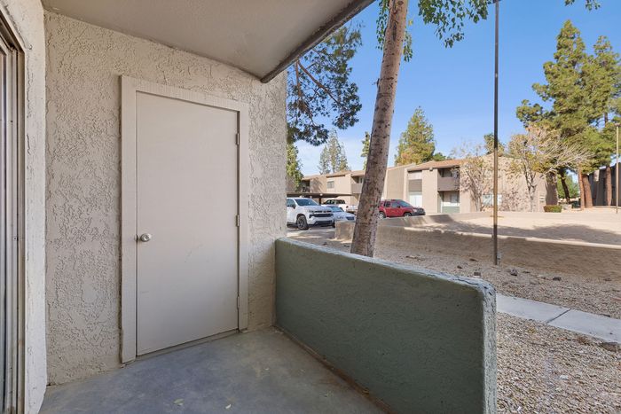Private concrete patio with an outdoor storage closet and views of the community.