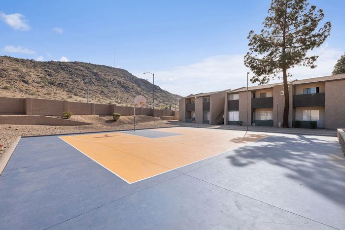 Outdoor basketball court with blue and orange surfacing at Solaris at Shadow Mountain.