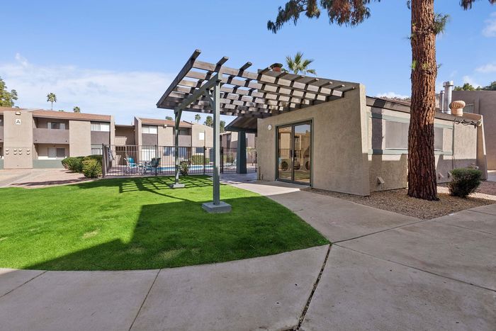 Outdoor trellis and grassy area near the swimming pool at Solaris at Shadow Mountain.