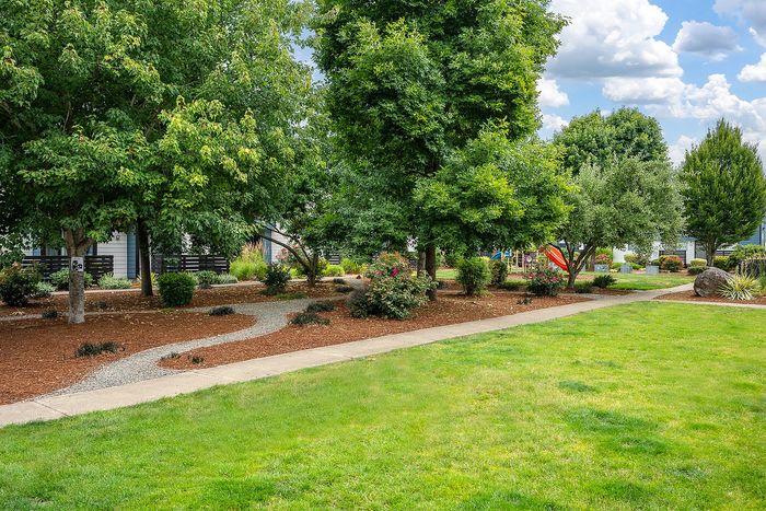 Exterior at Boulder Gardens with a walkway and tree