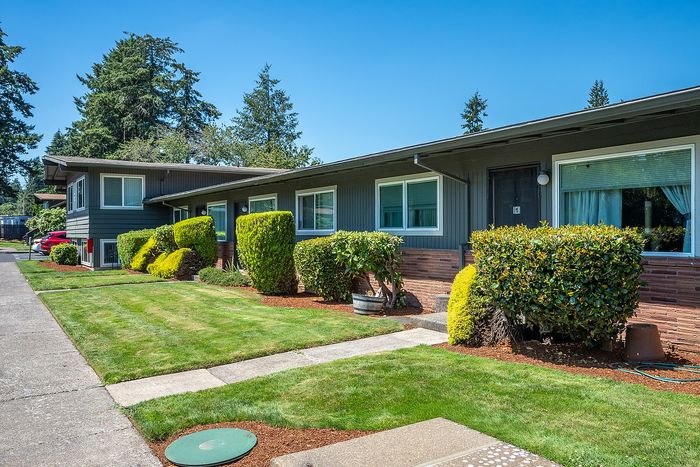 exterior of hidden court apartments with grass and exterior entries