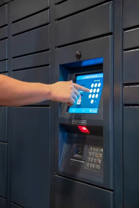 Modern apartment parcel locker with secure touchscreen key entry system.