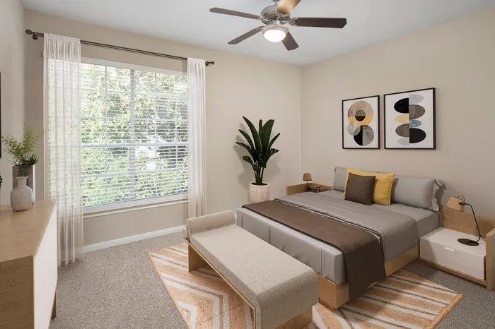 Cozy bedroom featuring a plush bed with modern pillows, artistic wall decor, and a large window overlooking greenery, creating a serene atmosphere.