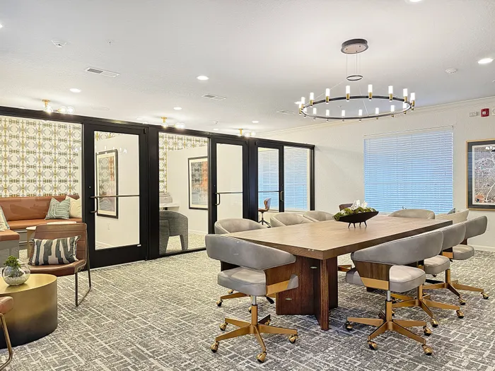 Luxurious modern lounge and conference area with chic decor, plush seating, and stylish lighting; perfect for meetings and relaxation.