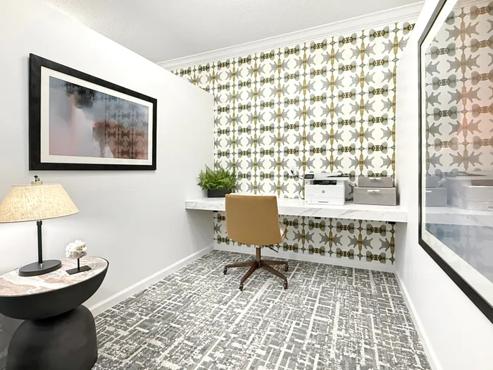 Chic home office space with modern wallpaper and elegant desk setup, perfect for productivity and style.