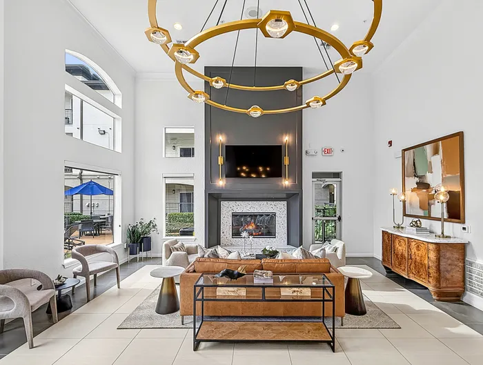 Elegant, modern living room with high ceilings, a cozy fireplace, and stylish seating area, perfect for relaxation and entertaining.